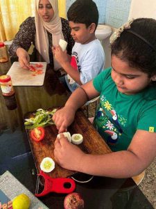 children cutting vegetables as a part of life skill camp